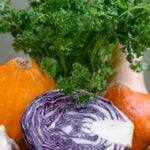 Cabbage and pumpkin on a wooden table, providing diet advice for senior health.