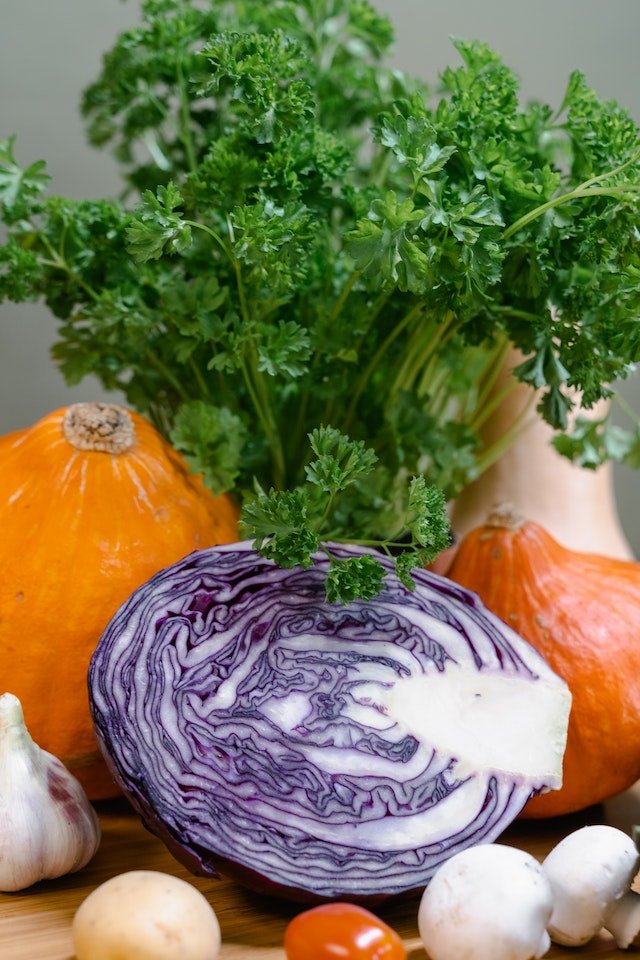 Cabbage and pumpkin on a wooden table, providing diet advice for senior health.