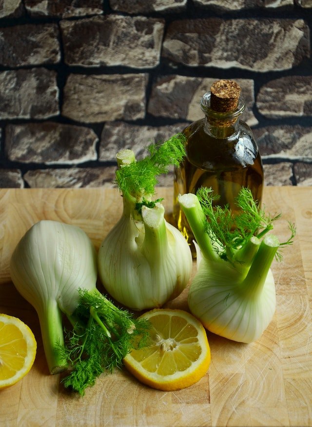 Wellness tips for seniors - Dill, lemon and olive oil on a wooden cutting board.