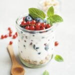 Yogurt with berries and mint in a jar, promoting senior health.