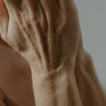 A woman's hands with wrinkles, showcasing signs of aging.