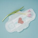 Sanitary pads with a tulip on a blue background designed to provide senior health and wellness tips during diet advice.