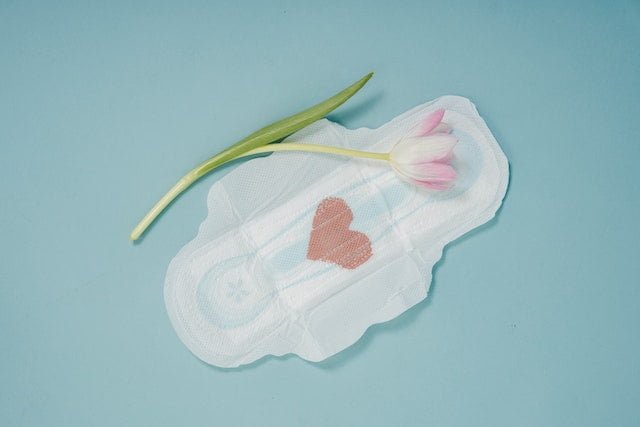 Sanitary pads with a tulip on a blue background designed to provide senior health and wellness tips during diet advice.