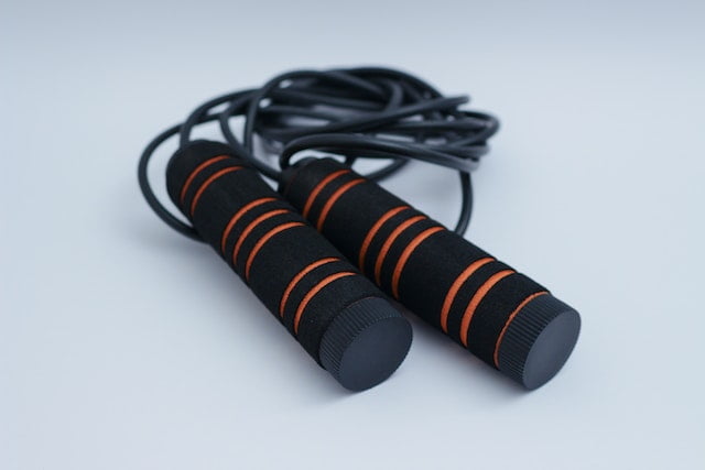 Two black and orange jump ropes on a white background, promoting senior health and longevity.