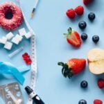 A pineapple, berries, and donuts on a blue background- a display of wellness tips for longevity and aging.