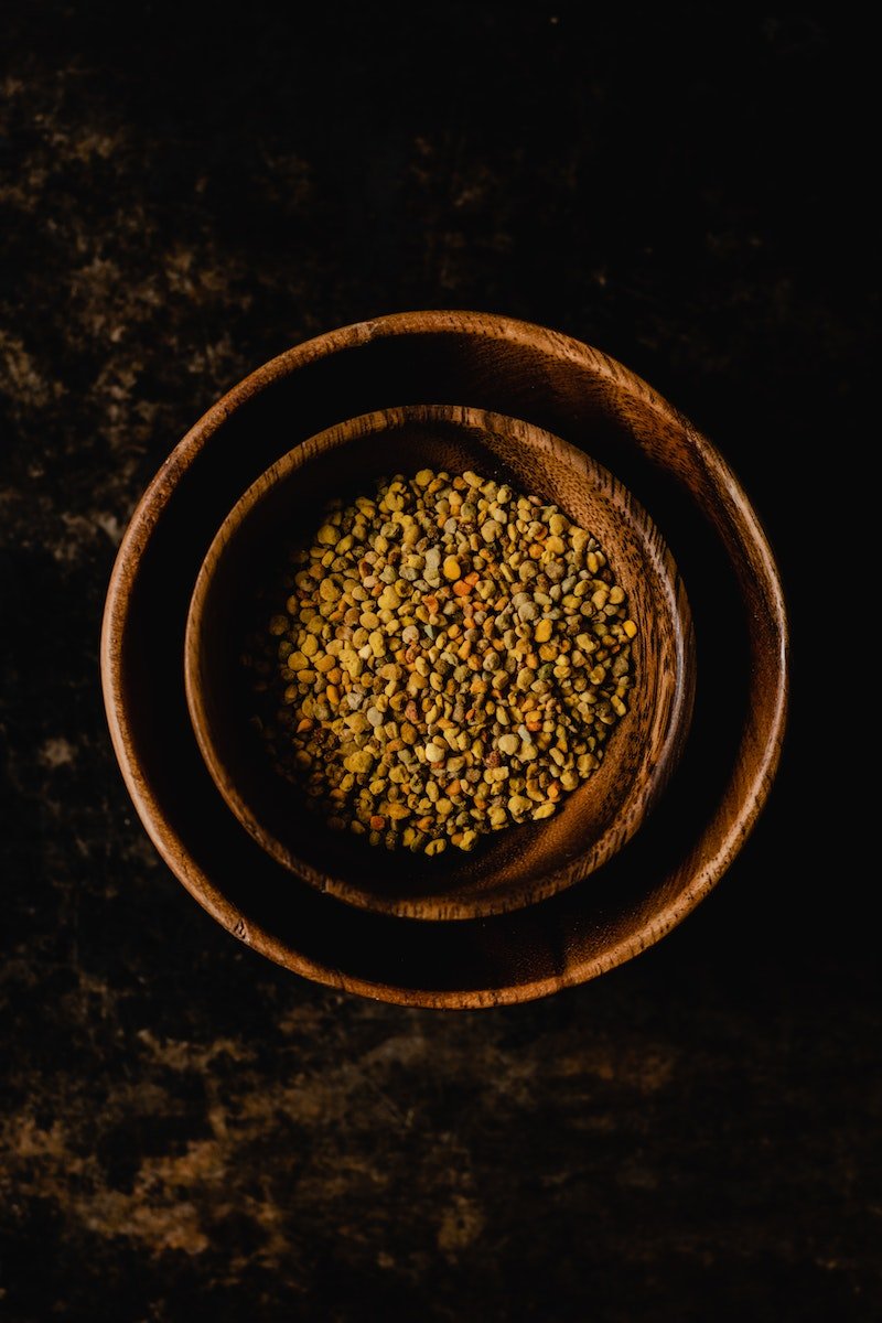 Two wooden bowls filled with seeds, providing essential diet advice for senior health on a dark background.