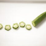 A plate of green peppers, known for their wellness and longevity benefits, showcased on a clean white plate.