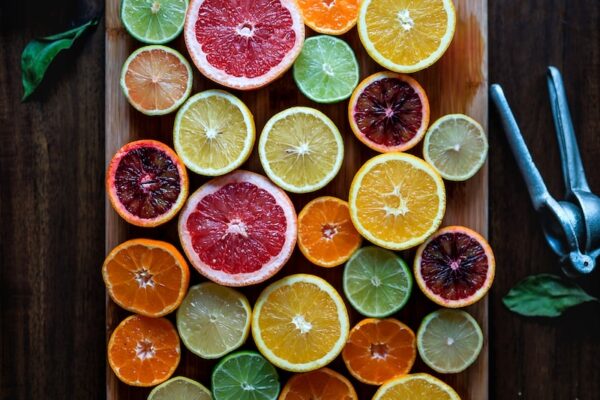 Anti-aging wellness tips featuring citrus slices on a wooden cutting board.