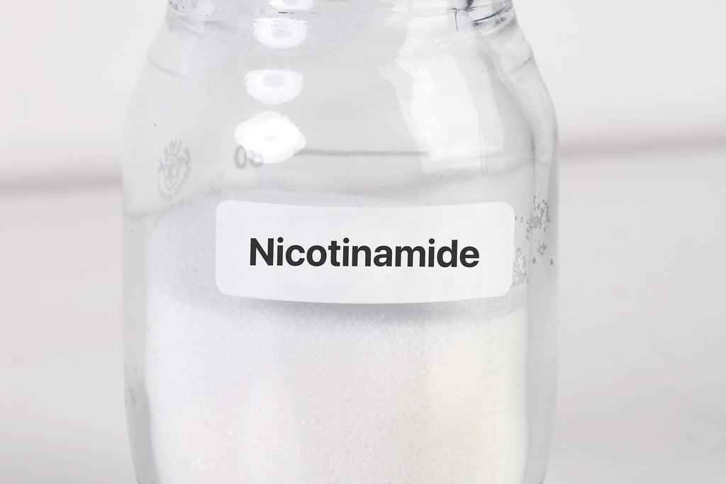 Nicotinamide, an effective anti-aging ingredient, stored in a glass jar.