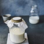 A jar of milk sitting on a table, promoting wellness tips.