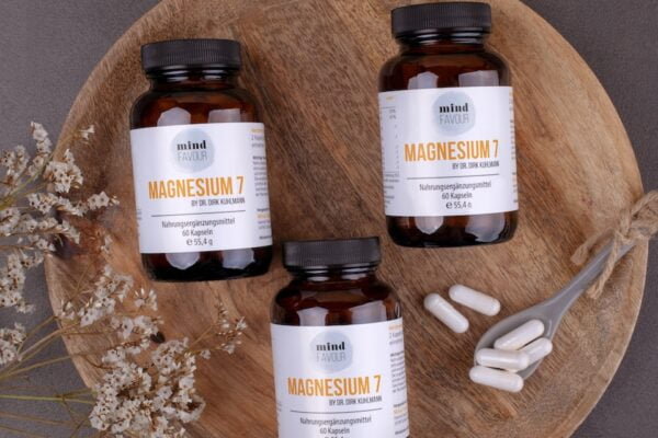 three bottles of magnesum on a wooden plate