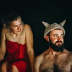 A man and woman in a red dress with horns on their heads share valuable diet advice for senior health and longevity tips.