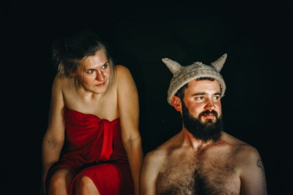 A man and woman in a red dress with horns on their heads share valuable diet advice for senior health and longevity tips.