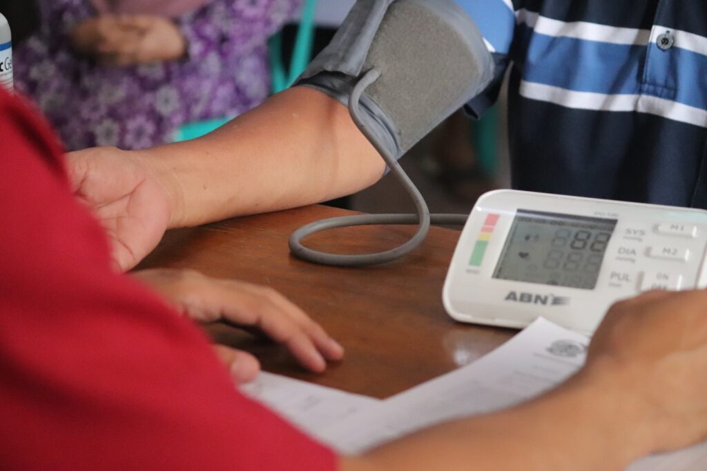a person with a blood pressure meter on a table